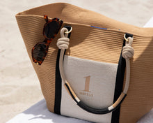 Load image into Gallery viewer, Beige tote bag with sunglasses on a sandy background